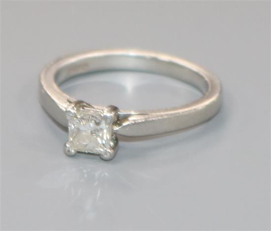 A platinum and solitaire princess cut diamond ring, size K.